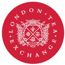 London Tea Exchange red logo with ornate white crest and text arranged in a circular emblem.