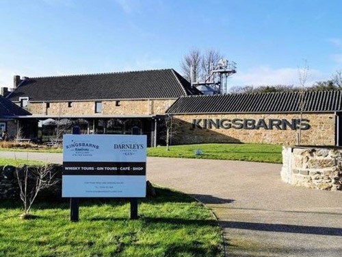 Kingsbarns Distillery entrance with signage offering whisky tours, gin tours, café and shop.