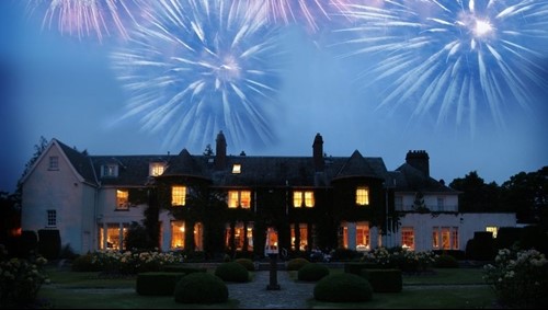 Fireworks lighting up the night sky above the illuminated Rufflets St Andrews house.